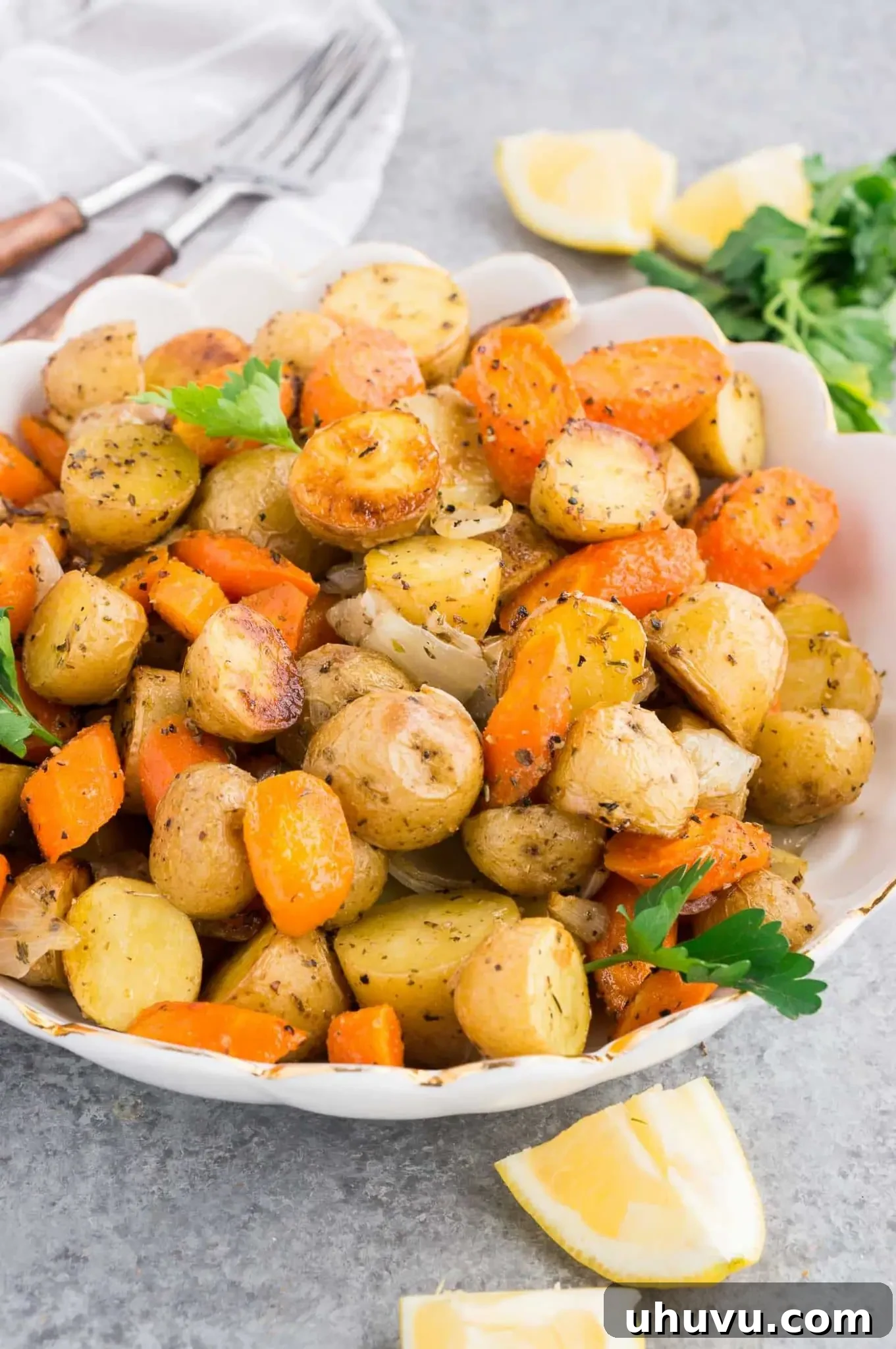 Golden Roasted Potatoes and Carrots 2 roasted potatoes and carrots and caramelized onions in a serving bowl
