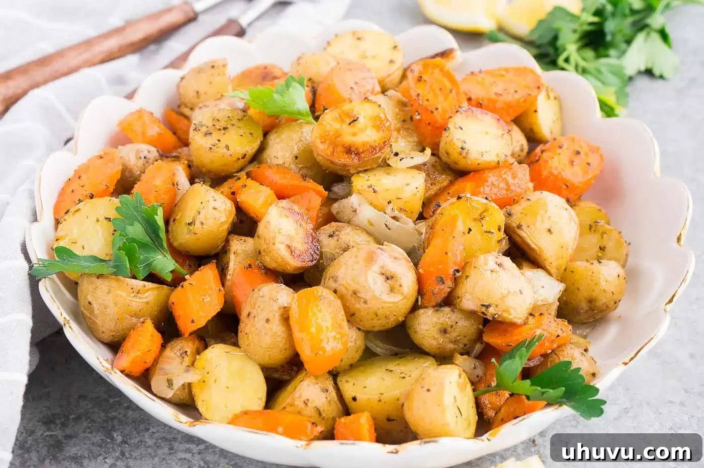 Golden Roasted Potatoes and Carrots 3 close up image of baked potatoes and carrots in a serving bowl