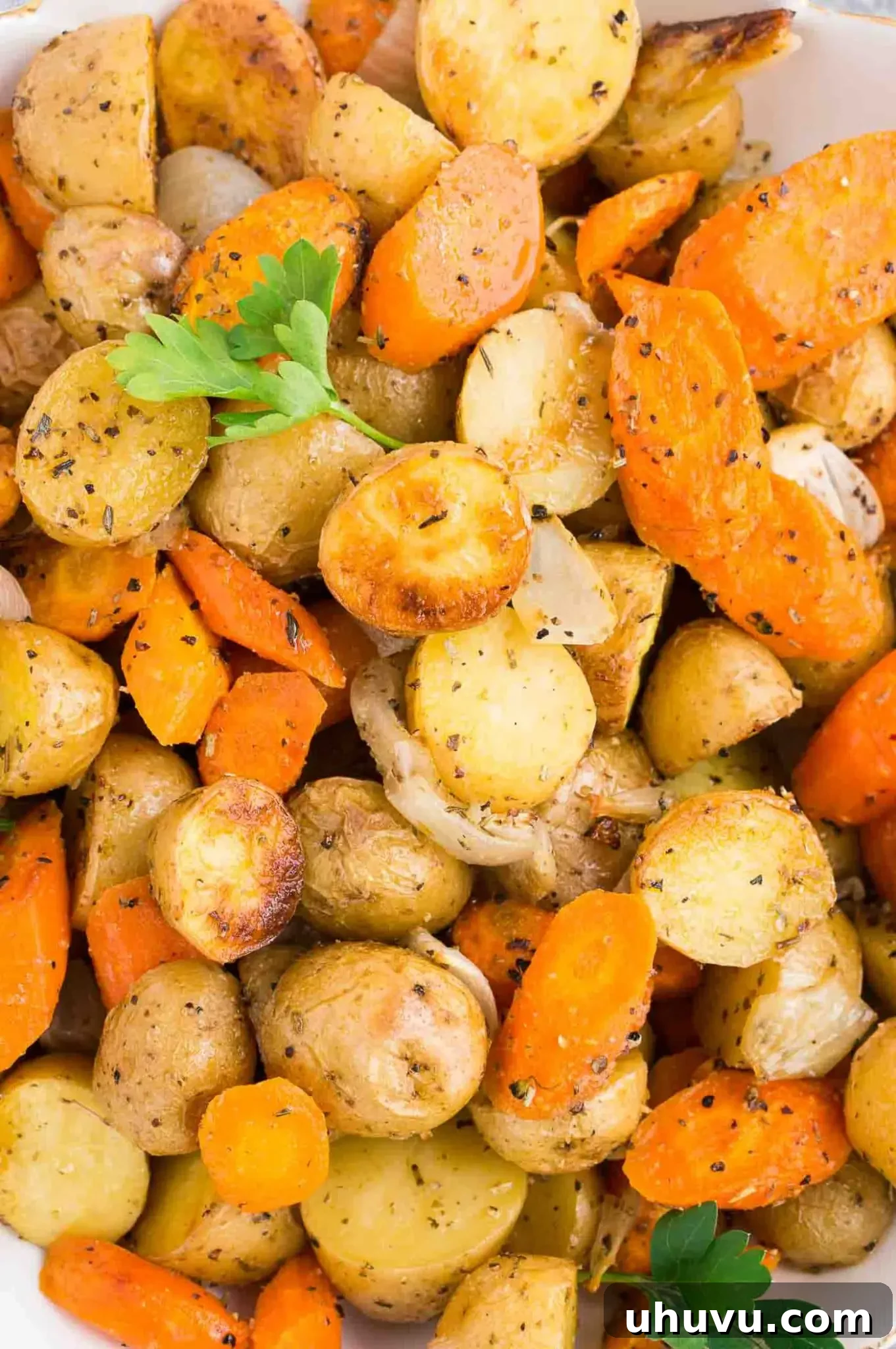 Golden Roasted Potatoes and Carrots 6 close up image of baked potatoes and carrots and onions