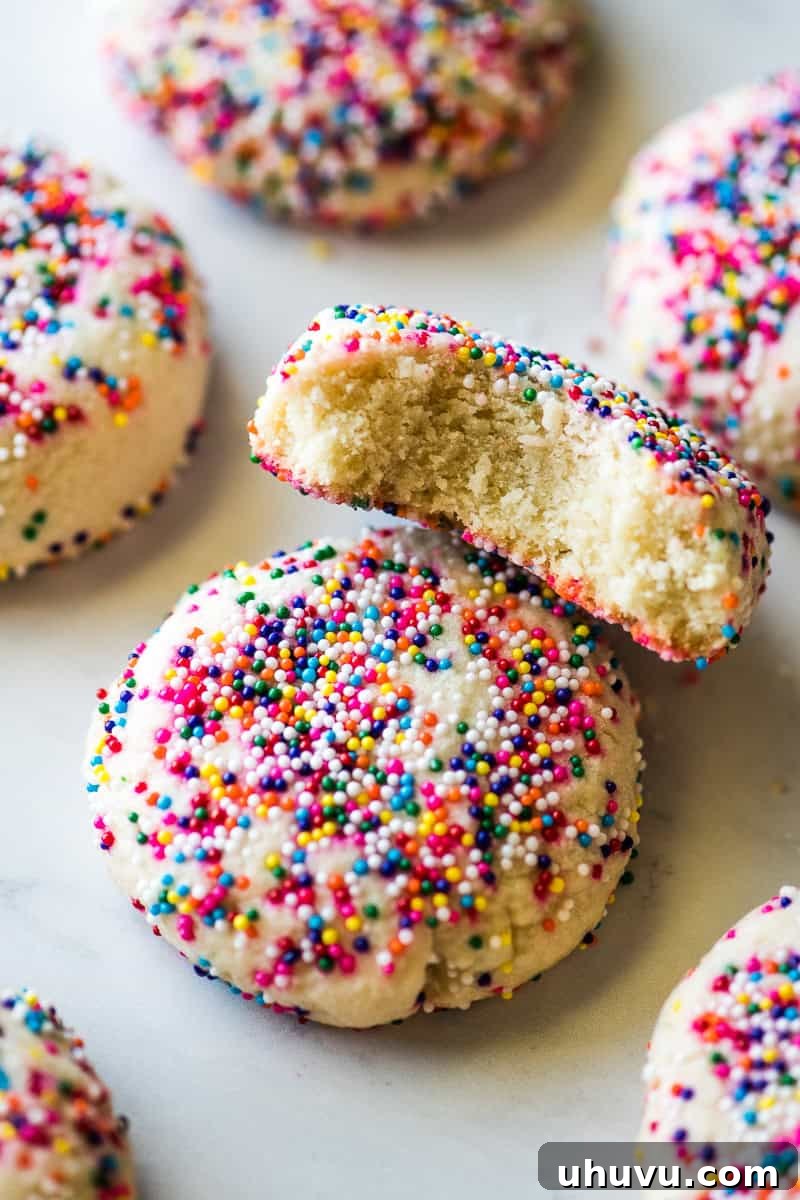 Effortless Funfetti Cookies 6 A sprinkle cookie with a bite taken out of it.