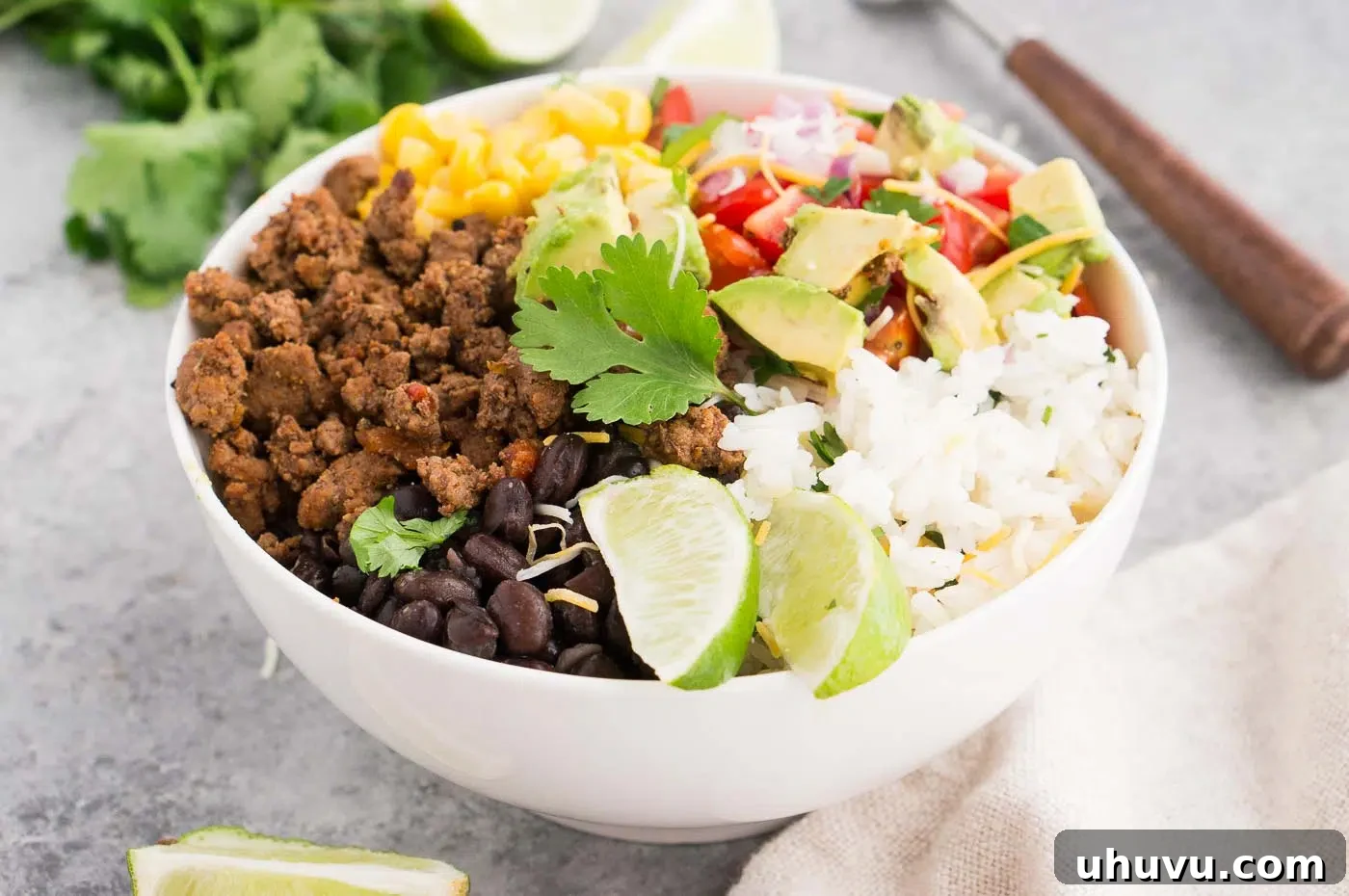 Taco meat and a colorful assortment of fresh vegetables arranged artfully in a bowl.