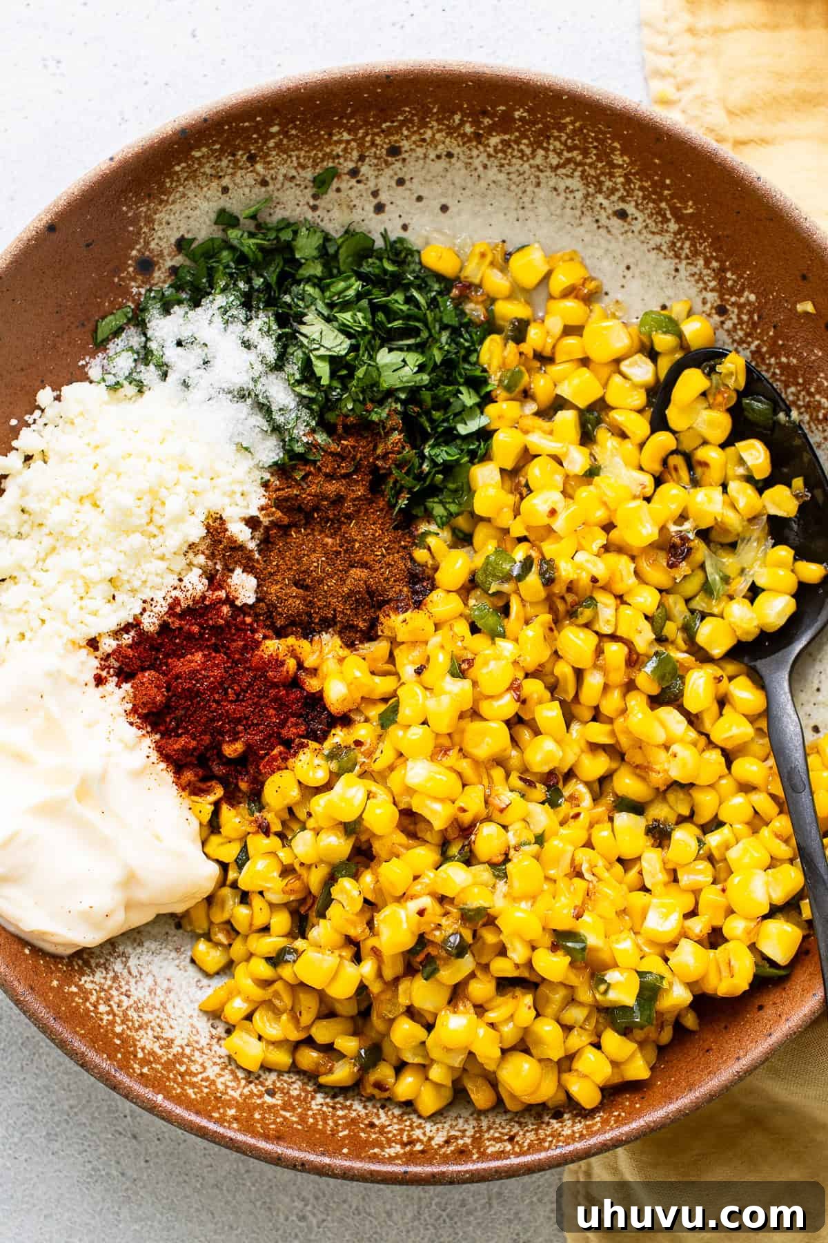 All ingredients added into a bowl and mixed together, showing the creamy Esquites texture