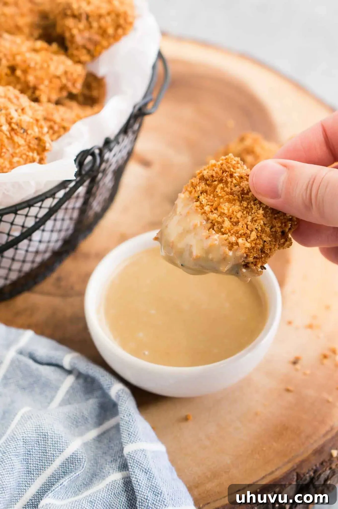 Crispy Homemade Chicken Nuggets 6 dipping a golden brown chicken nugget in a creamy honey mustard sauce
