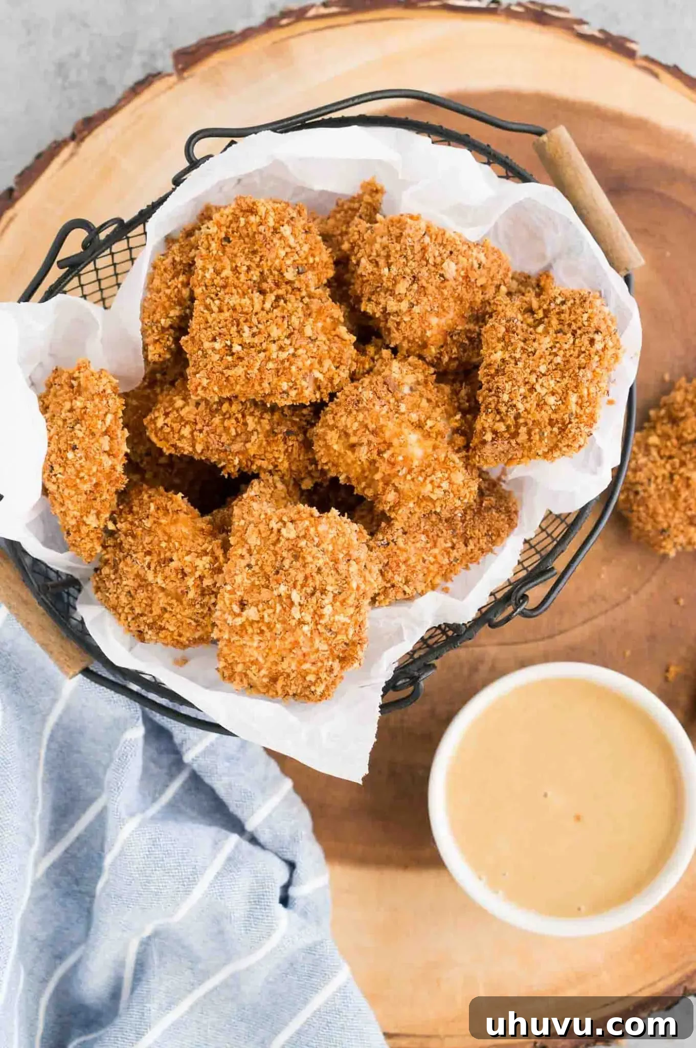 homemade chicken nuggets artfully arranged in a basket with dipping sauce