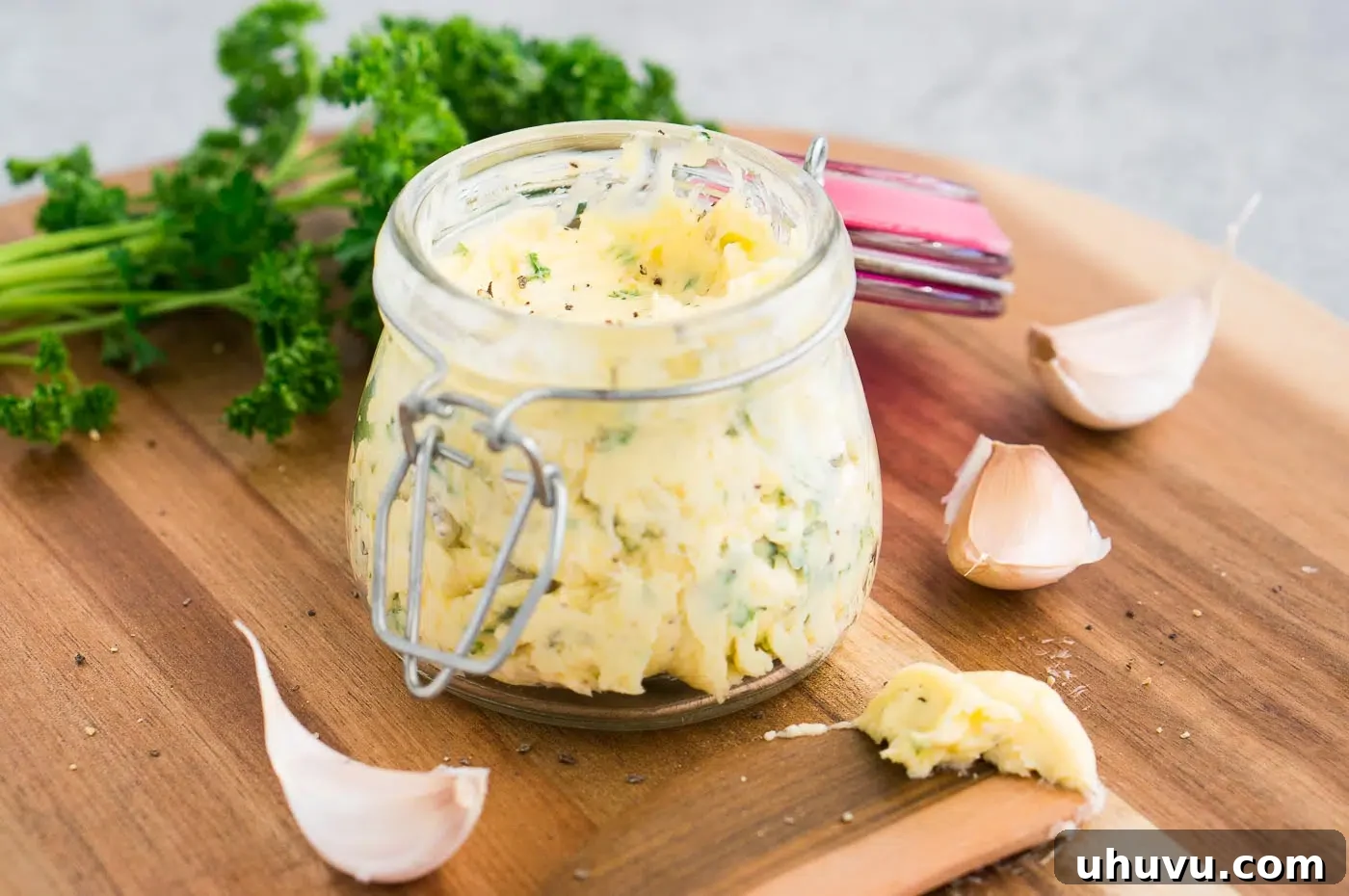 Homemade garlic butter in a decorative jar, ready to be used or stored.