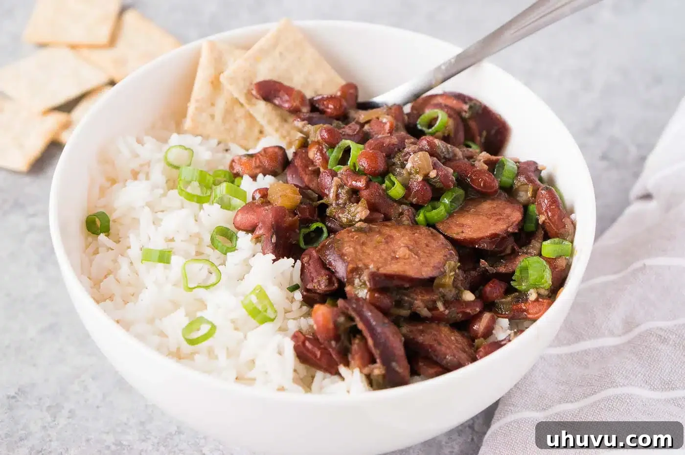 Southern Comfort Instant Pot Red Beans and Rice 3 A close-up of creamy Instant Pot Red Beans and Rice with chunks of sausage in a serving bowl.