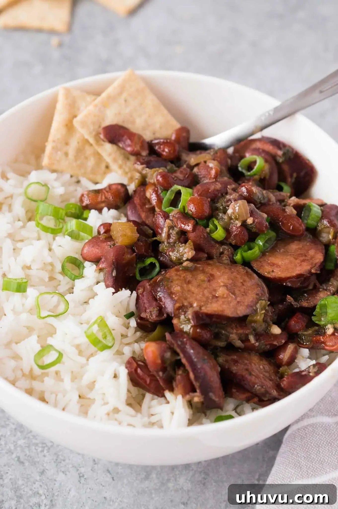 A top-down view of a large serving bowl filled with pressure cooker red beans and rice with sausage, ready to be enjoyed.