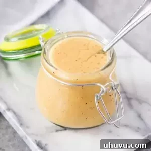 close up image of honey and mustard dressing for salad