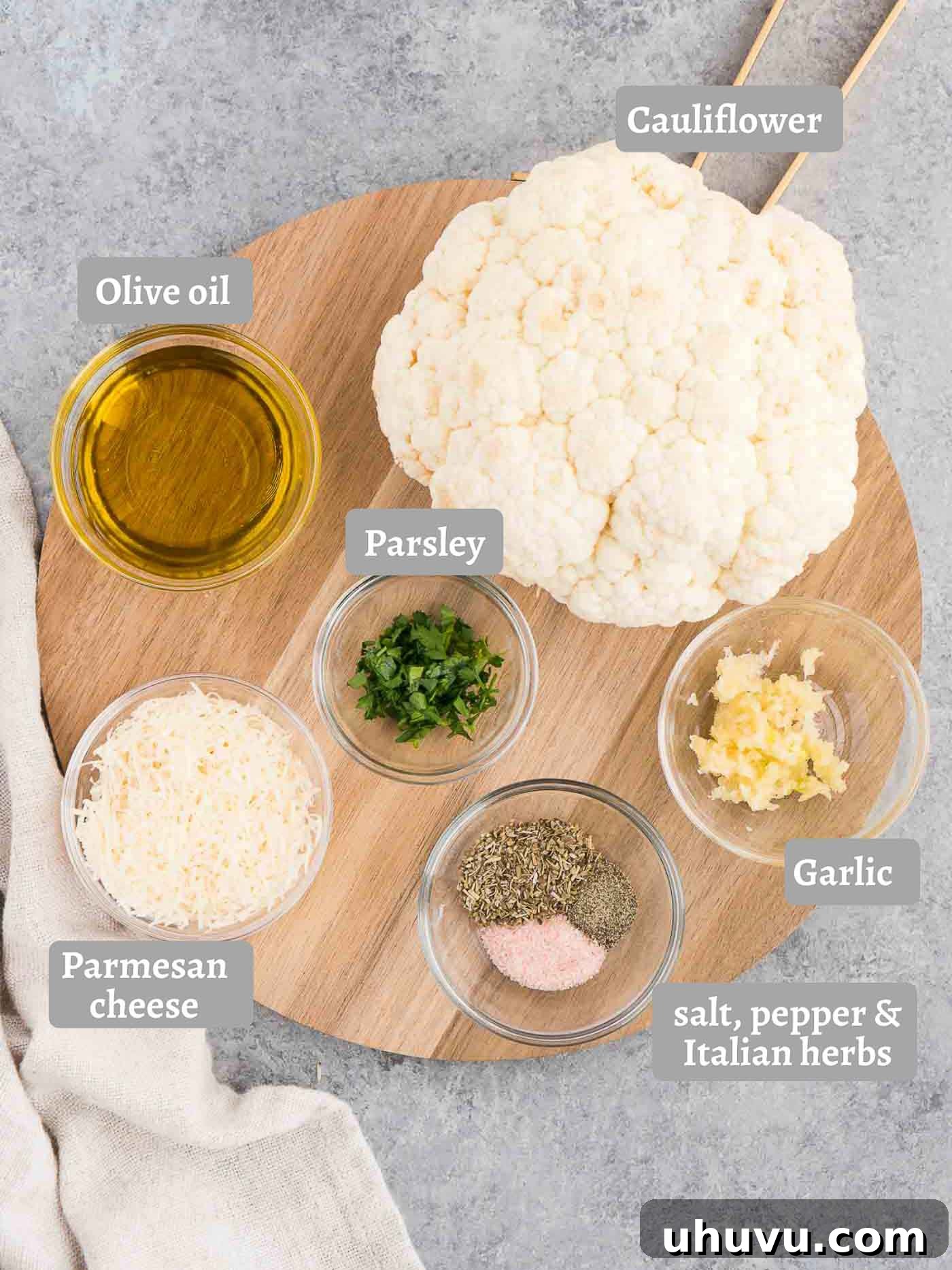 Showstopping Whole Roasted Cauliflower 3 Ingredients for making whole roasted cauliflower on a wooden board