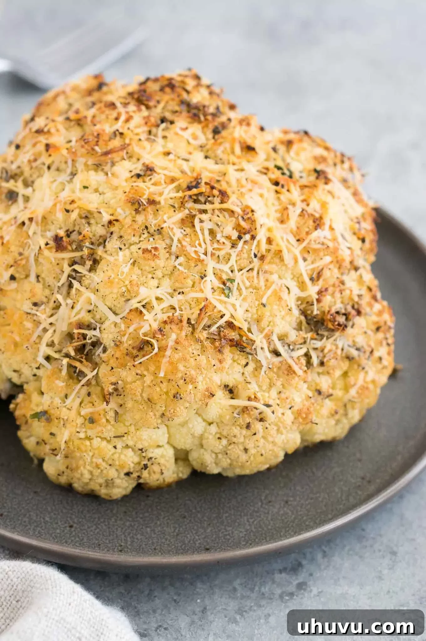 Beautifully plated whole roasted cauliflower, ready to be served