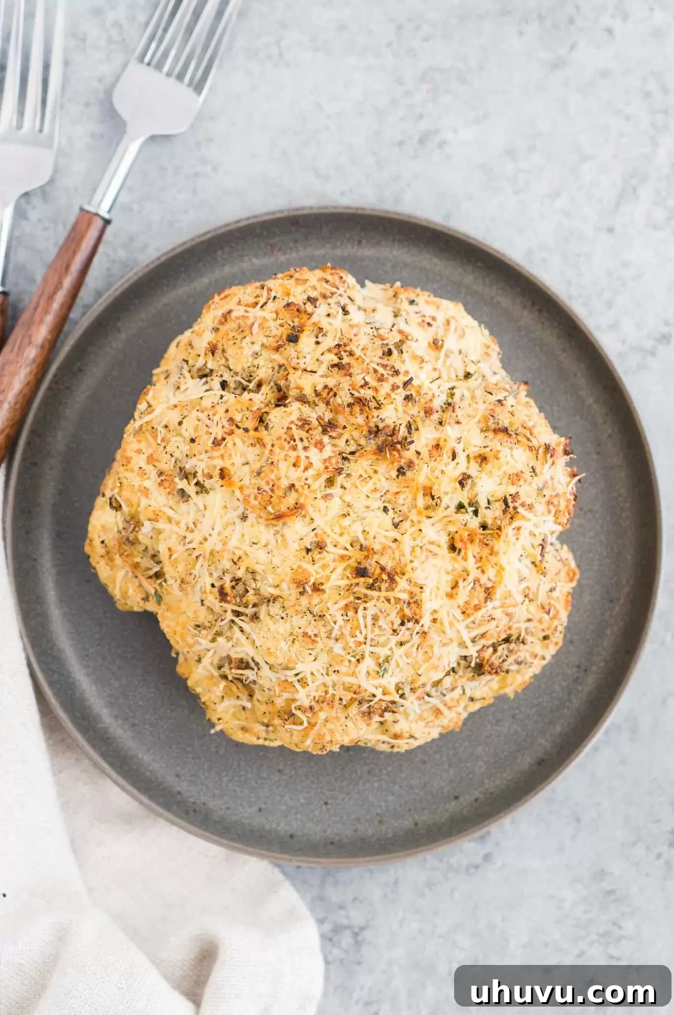Freshly baked whole cauliflower on a serving plate