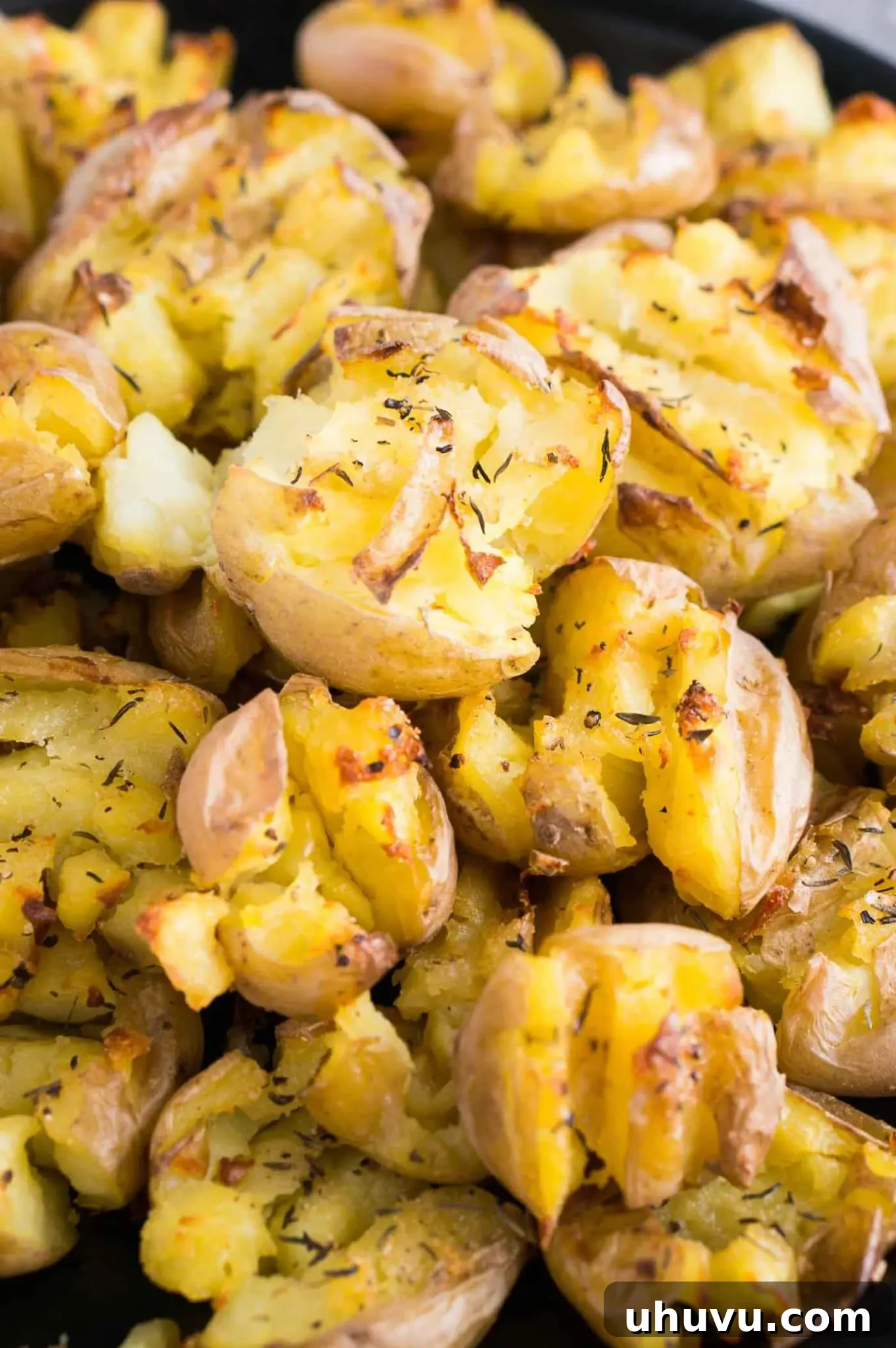 Close-up image of a stack of crispy smashed baby potatoes