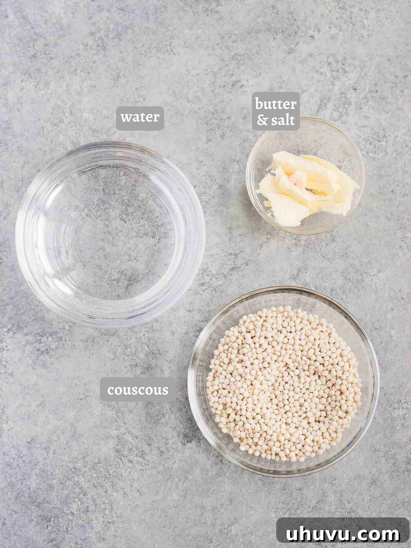 Unlock the Secrets to Delicious Couscous 4 Ingredients laid out for making couscous, including couscous pearls, water, salt, and butter.
