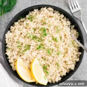 cooked couscous in a bowl with lemon slices