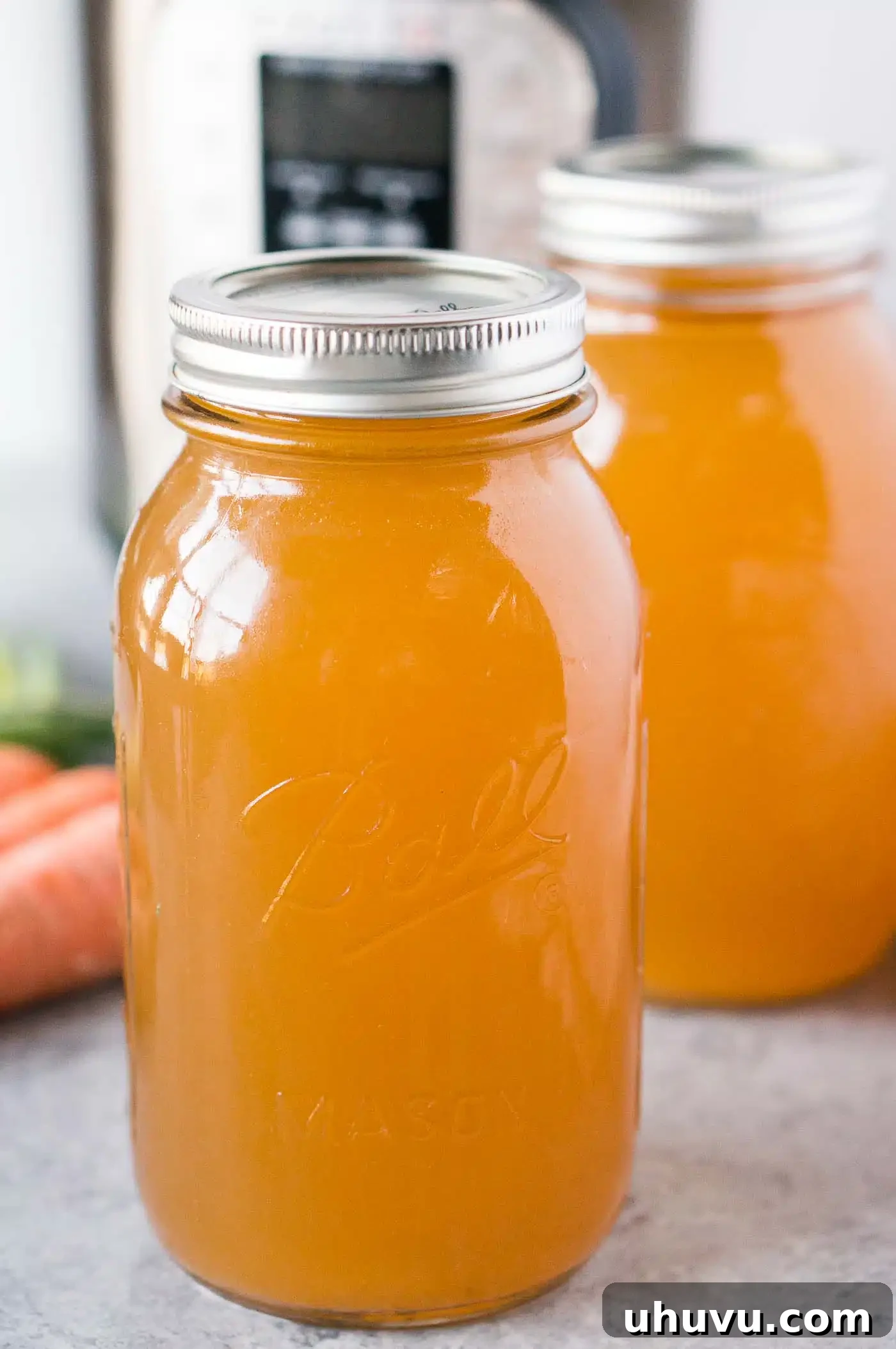 Homemade Turkey Stock 7 Close-up of golden homemade turkey stock in a glass jar, showcasing its rich color and clarity