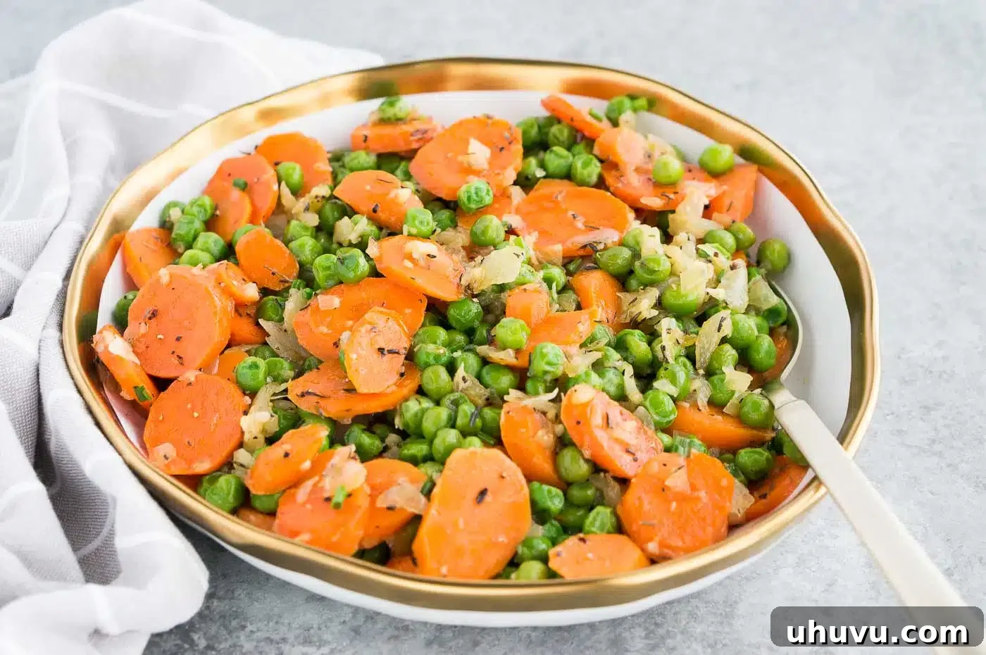 Orange and Green Harmony 3 sauteed carrots, peas and onions in a serving bowl