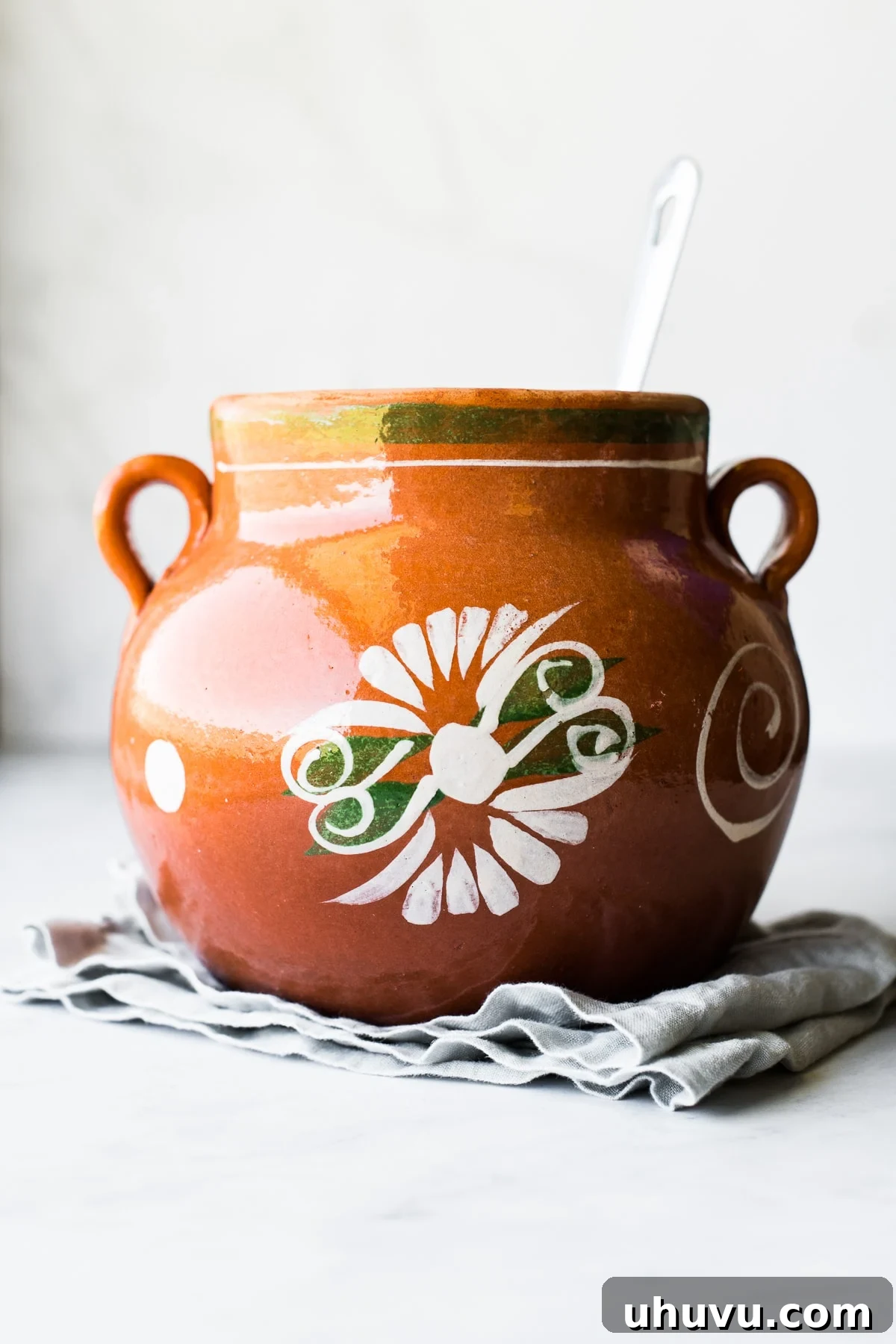 Spiced Olla Coffee 3 A large olla de barro, a traditional Mexican clay pot, typically used for cooking beans, stews, and brewing Café de Olla.