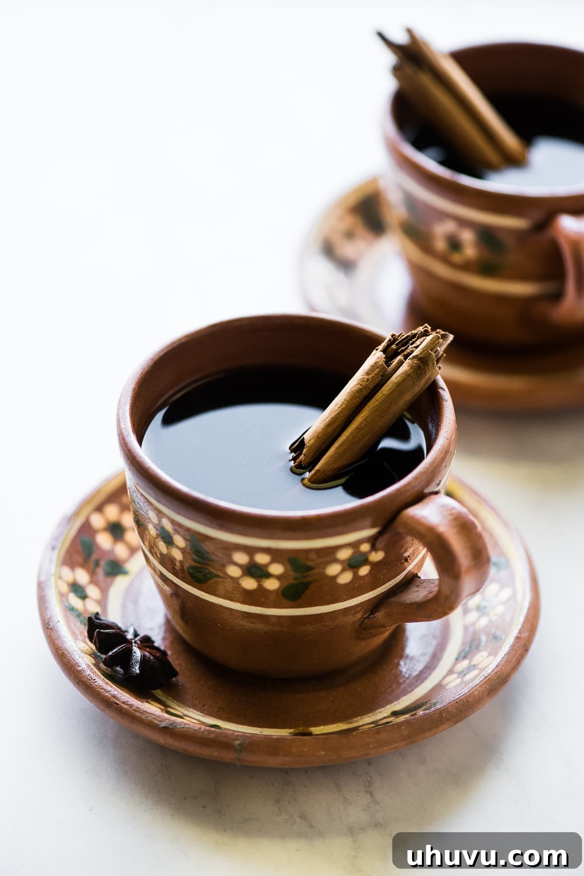 Spiced Olla Coffee 6 A charming clay mug filled to the brim with steaming Café de Olla, showcasing the rich color and inviting warmth of traditional Mexican coffee.
