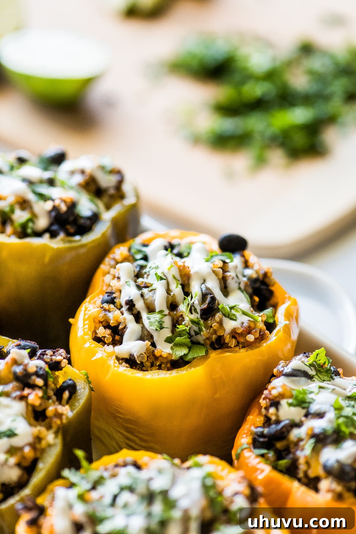 Slow-Cooked Stuffed Pepper Perfection 6 Stuffed peppers topped with sour cream and cilantro.