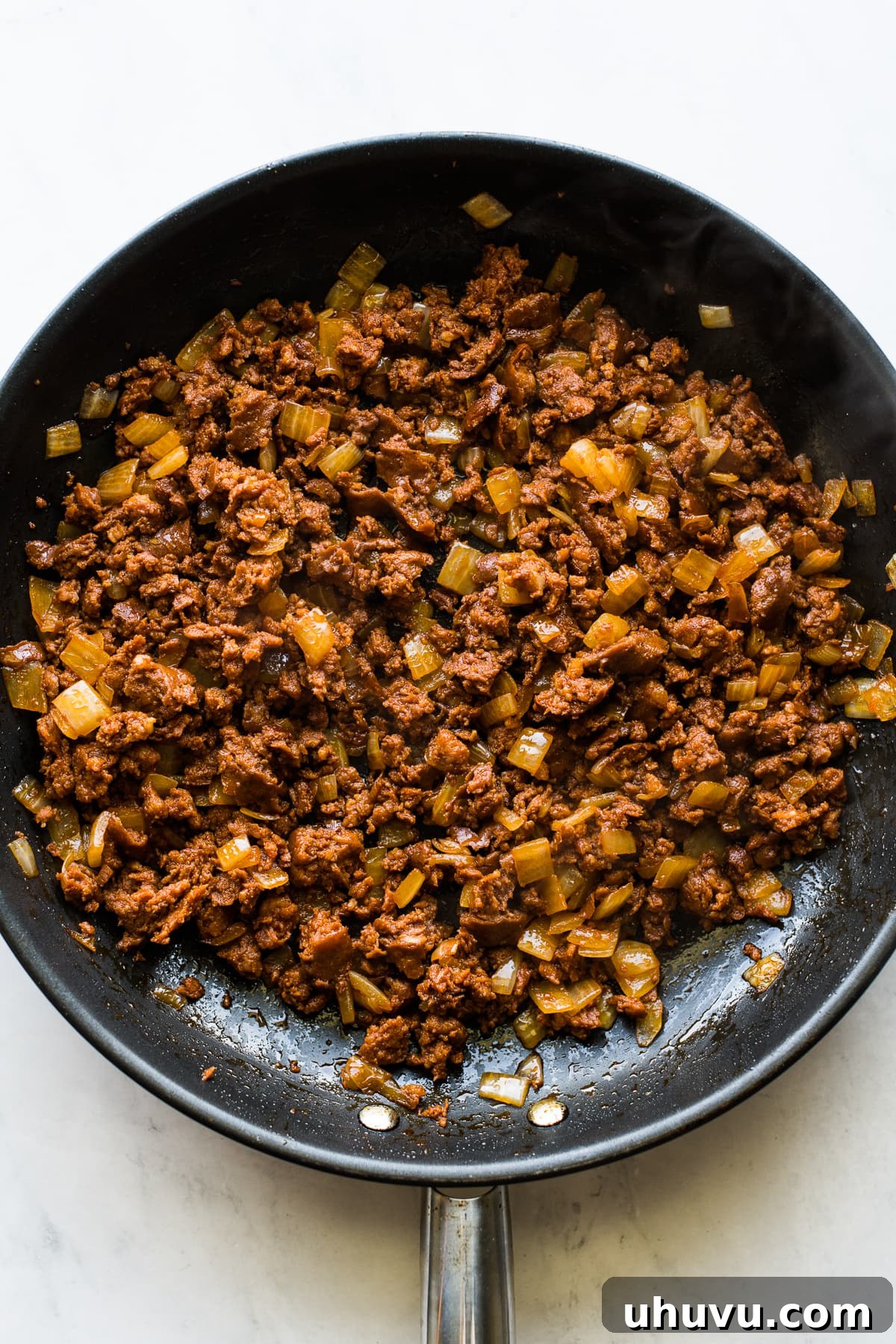 Sizzling Chorizo Potatoes 4 Cooked chorizo and onions in a skillet.