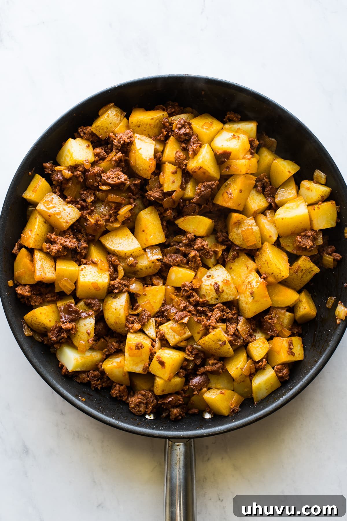 Sizzling Chorizo Potatoes 5 Papas con chorizo cooking in a large skillet.