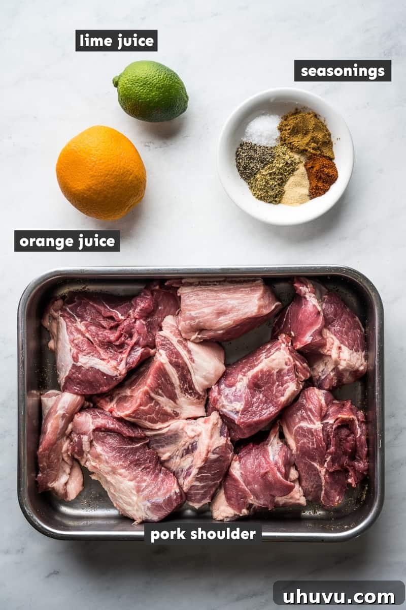 Slow-Cooked Pork Perfection 3 Essential ingredients for a delicious carnitas recipe, including a bowl of aromatic spices, fresh orange and lime halves, and a raw pork shoulder ready for preparation.