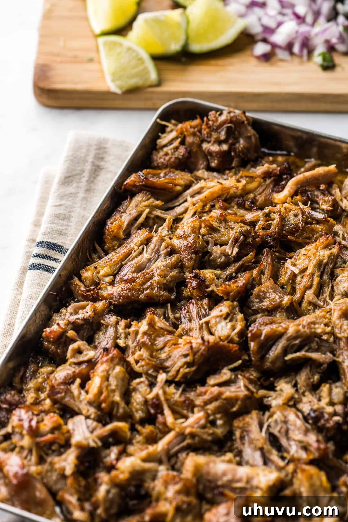 Slow-Cooked Pork Perfection 7 Deliciously crispy and juicy carnitas spread on a baking sheet, perfectly cooked and ready to be served in a variety of Mexican dishes.