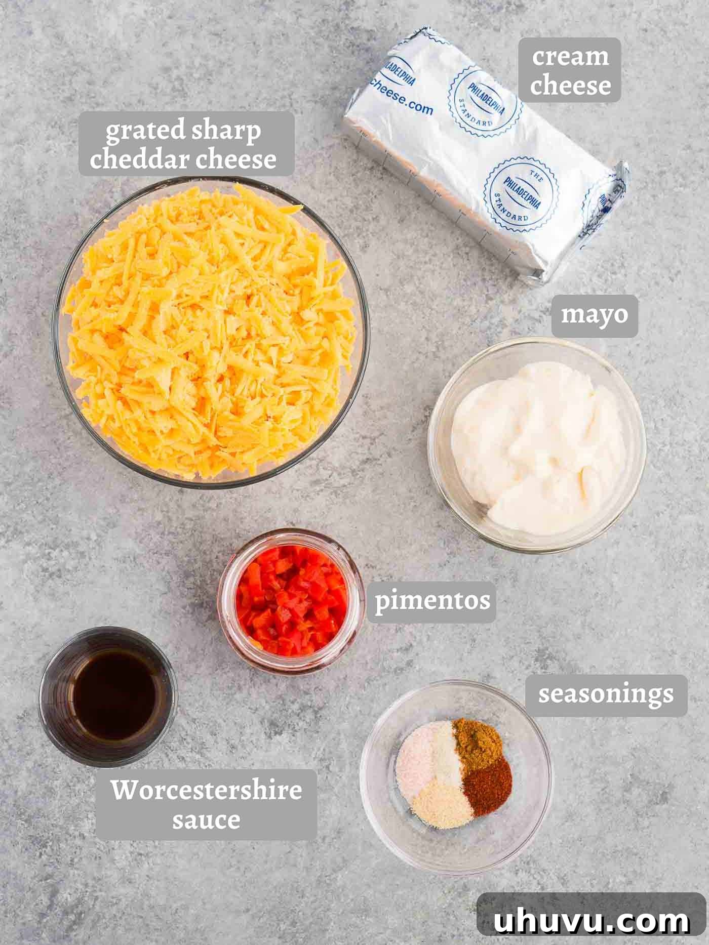 Southern Spread Sensation 4 Individual ingredients laid out for homemade pimento cheese including cheese, pimentos, cream cheese, and various spices.