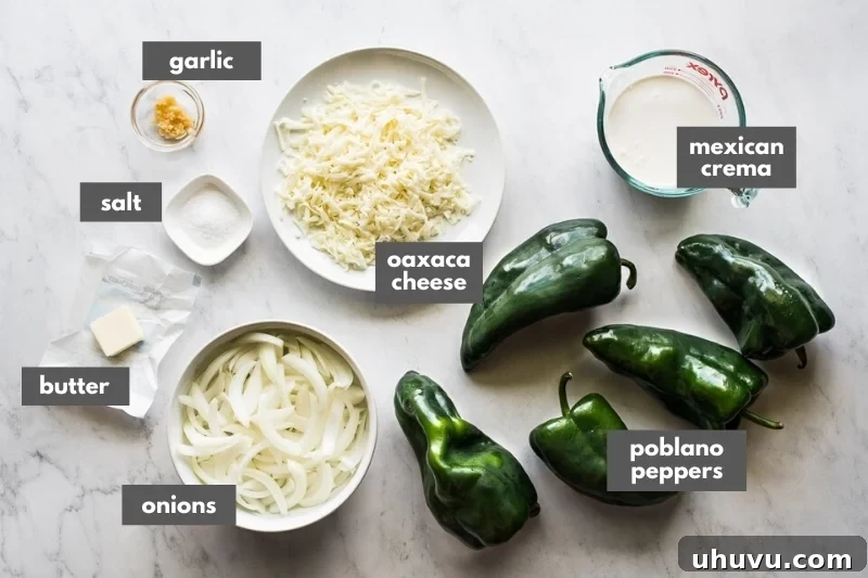 All the fresh ingredients laid out for making Rajas con Crema, including poblano peppers, onions, garlic, butter, Mexican crema, and Oaxaca cheese.