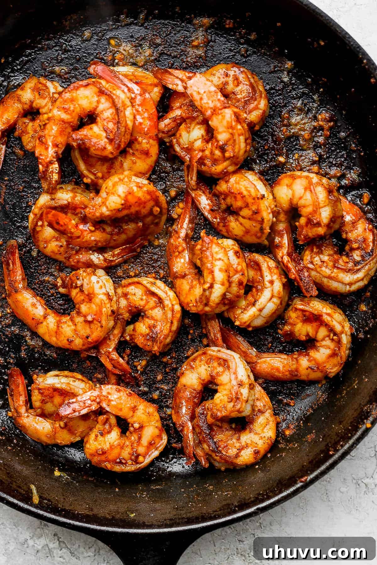 Vibrant Lime Shrimp Fajitas 6 Close-up of perfectly cooked, pink, and succulent jumbo shrimp in a skillet, seasoned and ready to be combined with the fajita vegetables.