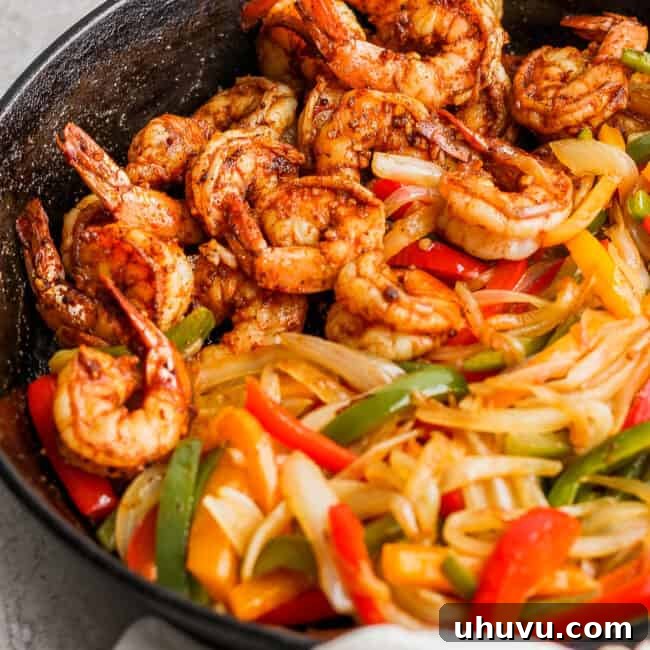 Shrimp Fajitas in a cast-iron skillet ready to be served, a perfect one-pan meal.