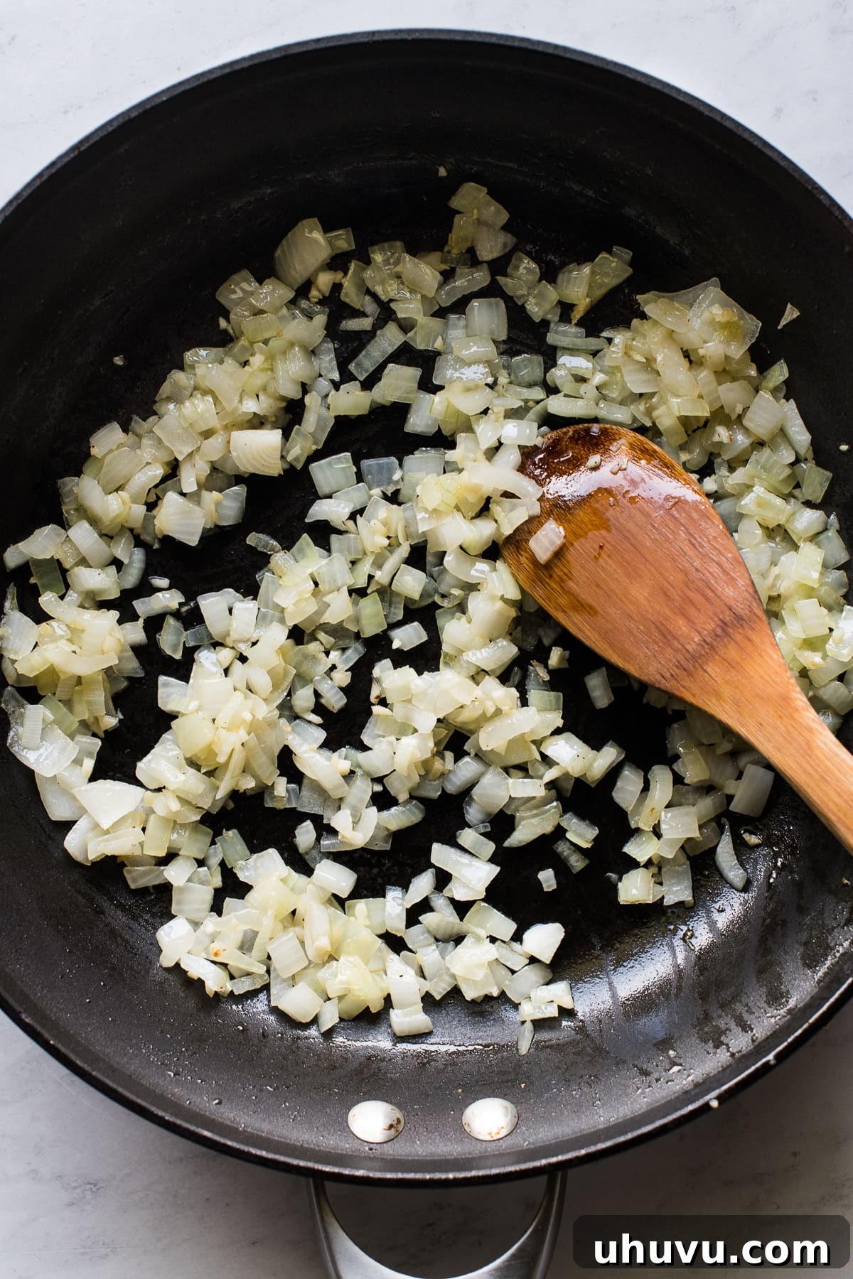 Salsa-Poached Eggs 6 Onion and garlic sauteeing in a skillet.