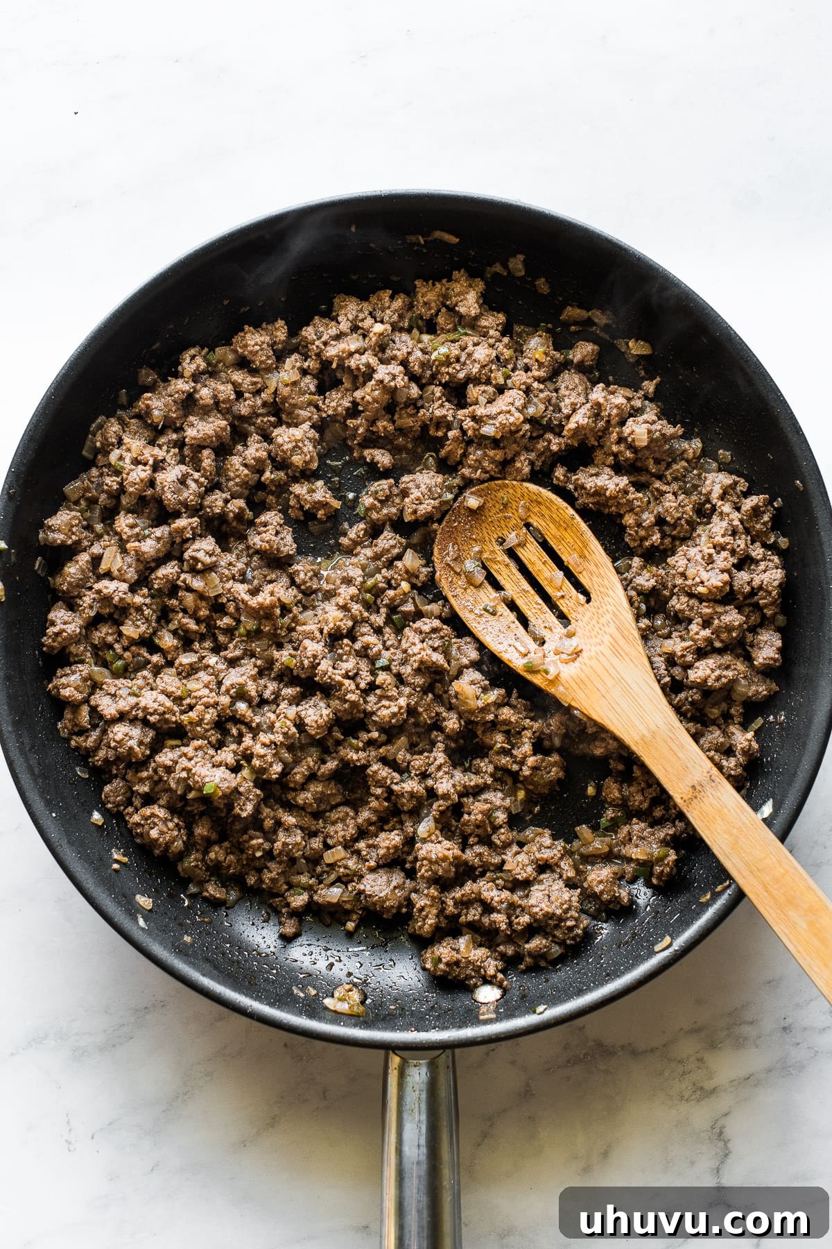 Hearty Beef Enchilada Fiesta 4 Ground beef sauteed in a large skillet for beef enchiladas.