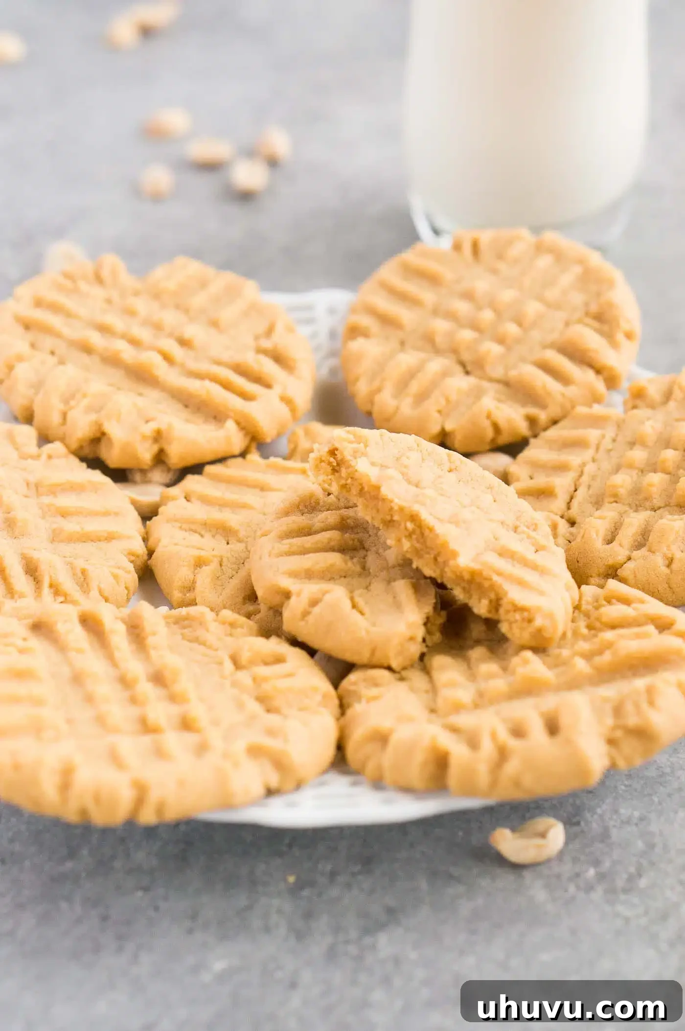 Irresistible Peanut Butter Bites 7 A plate of peanut butter cookies with a glass of milk in the background, a delightful dessert