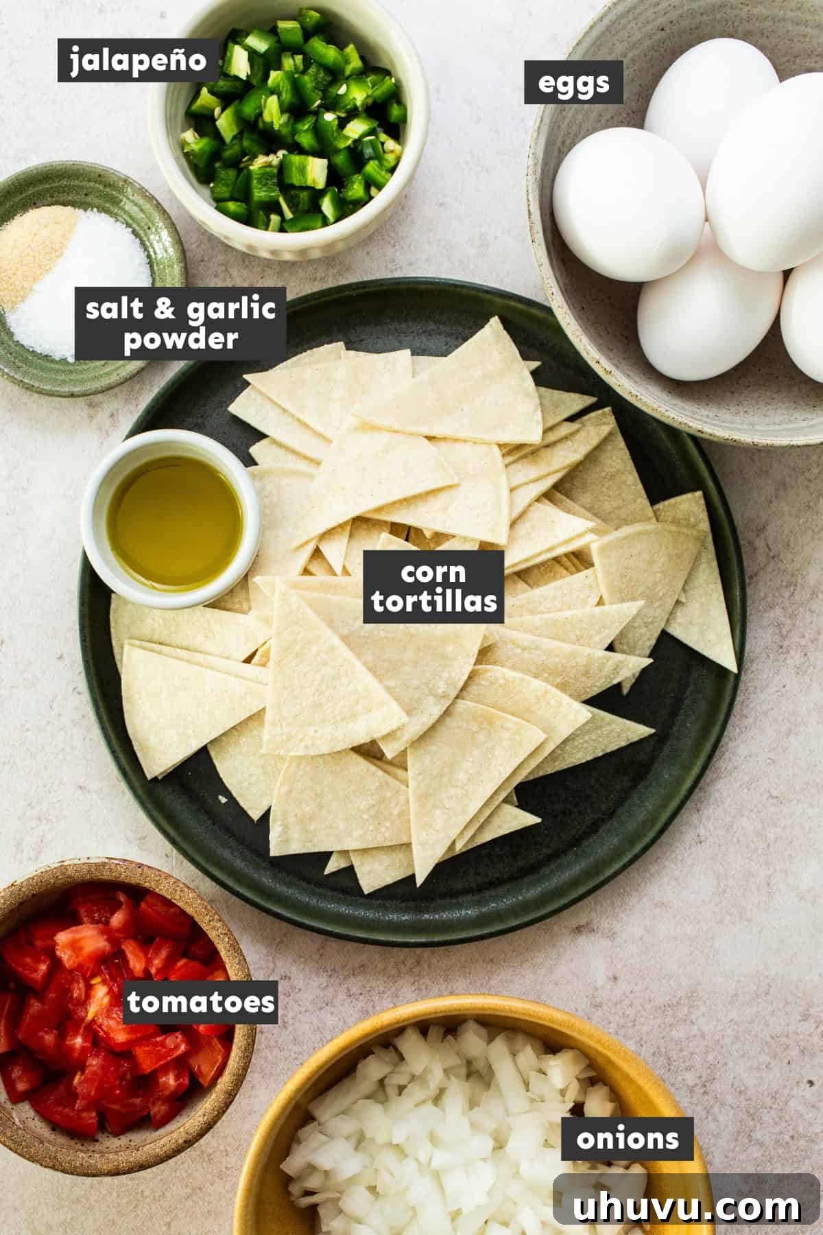 All of the ingredients to make migas laid out on a table.