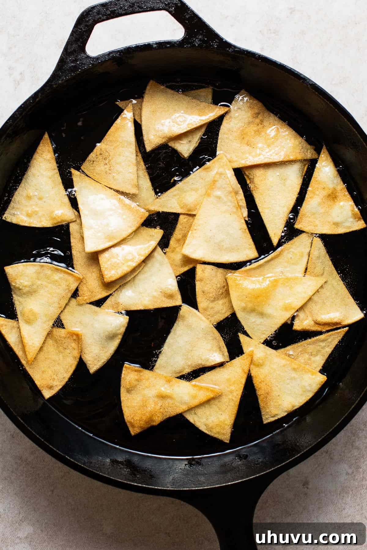 In a hot large skillet fry the tortilla chips.