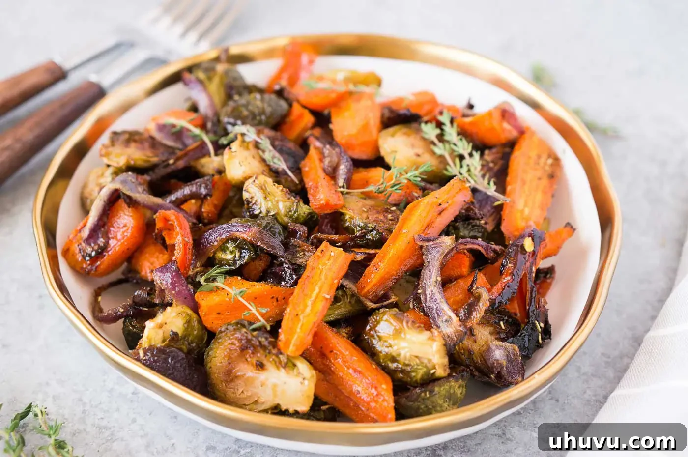 roasted brussel sprouts, carrots, and onions in a bowl serve for thanksgiving table
