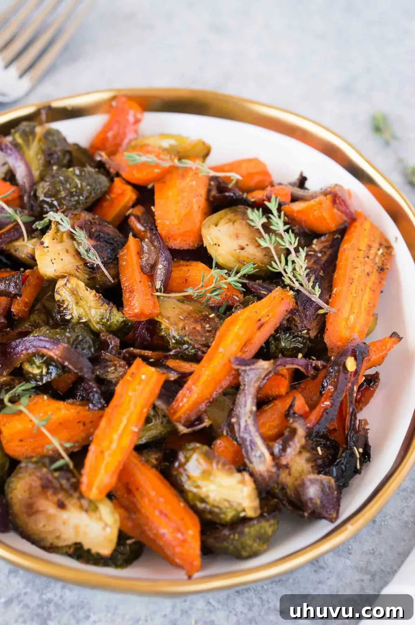 roasted Brussels spouts onions and carrots in a bowl