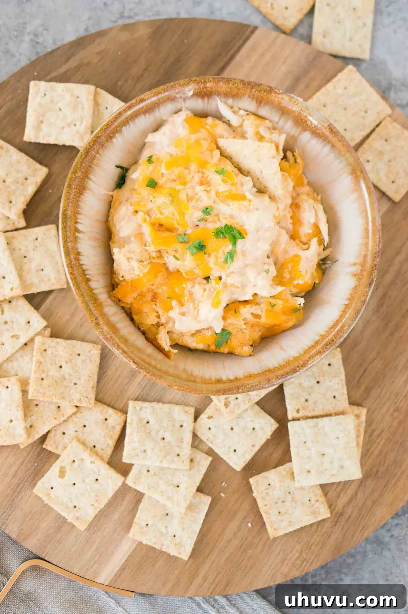image from top of hot crab dip in a bowl served with crackers