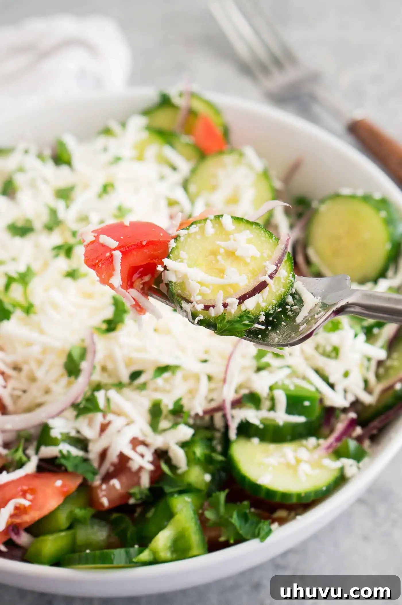 Authentic Bulgarian Shopska Salad 3 cucumber tomato and grated feta salad in a bowl, close up of fresh ingredients