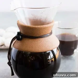 pour over coffee and a coffee cup in background