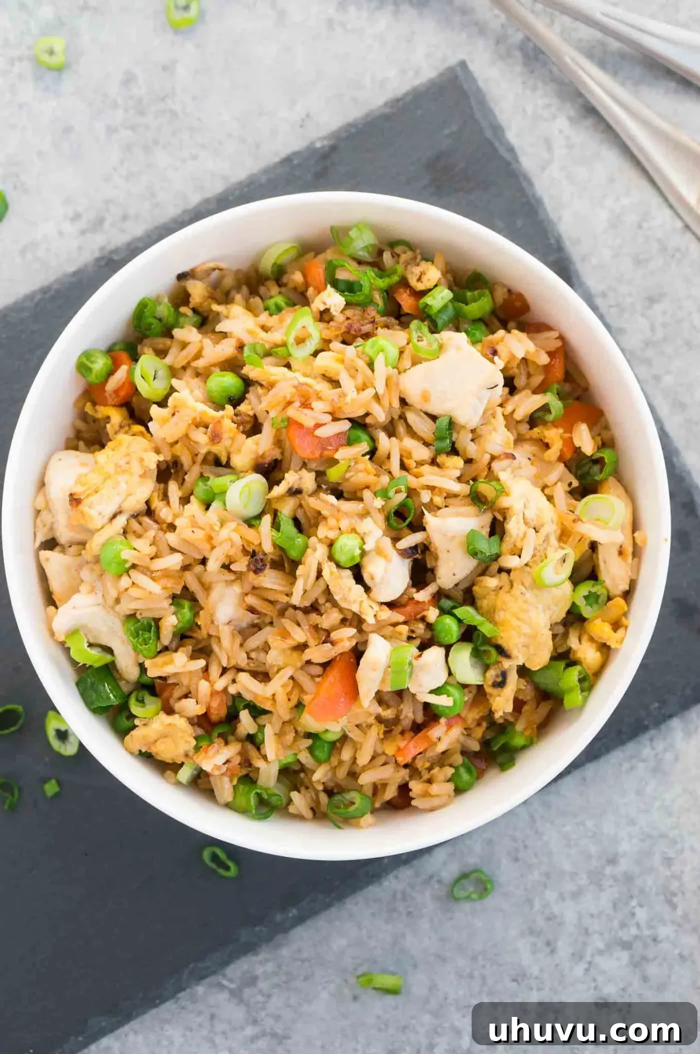 fried rice and chicken in a white bowl
