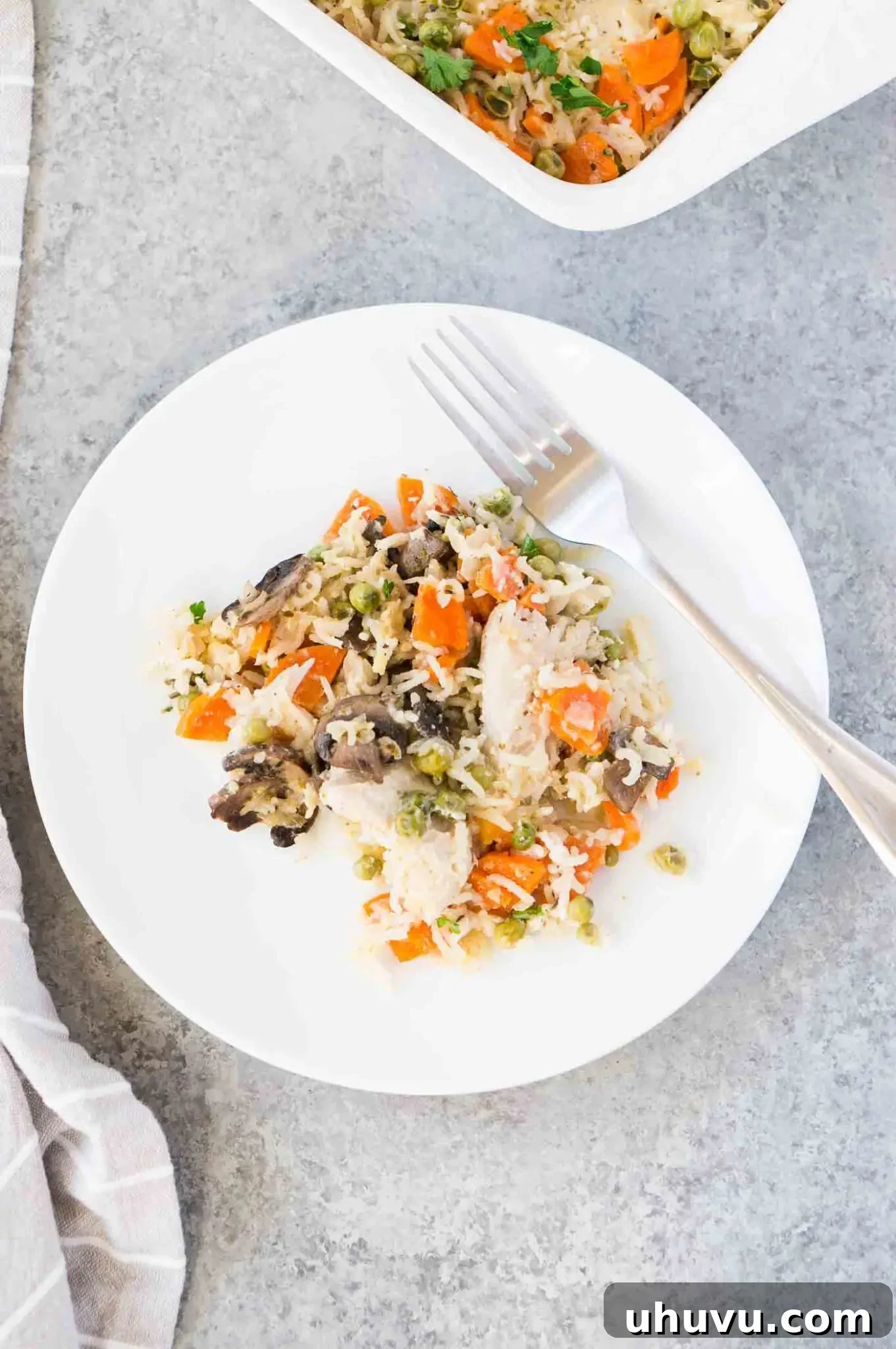 Chicken and rice bake served on a plate with fresh parsley garnish