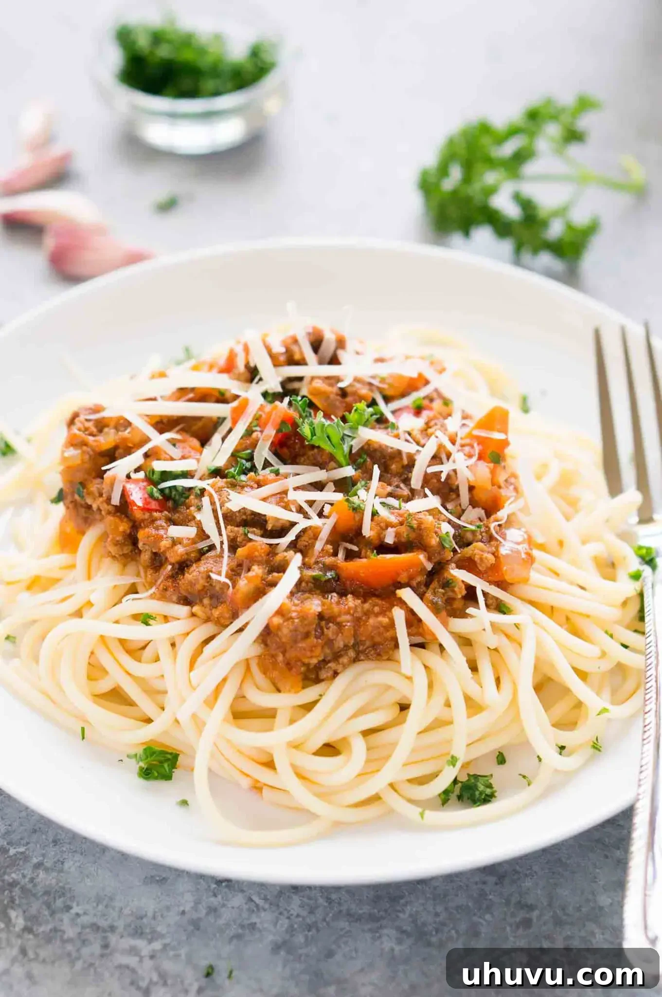 Ultimate Instant Pot Bolognese 2 A vibrant bowl of Instant Pot Bolognese sauce served over perfectly cooked spaghetti, garnished with fresh basil.