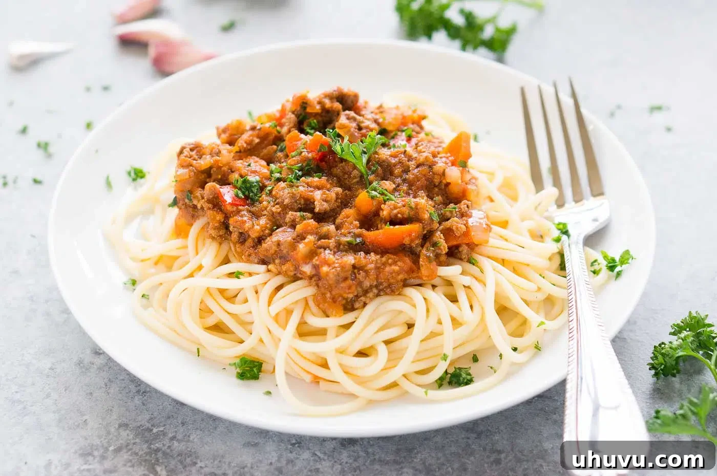 Ultimate Instant Pot Bolognese 3 A close-up view of rich, thick Bolognese sauce generously coating al dente spaghetti strands, ready to be enjoyed.