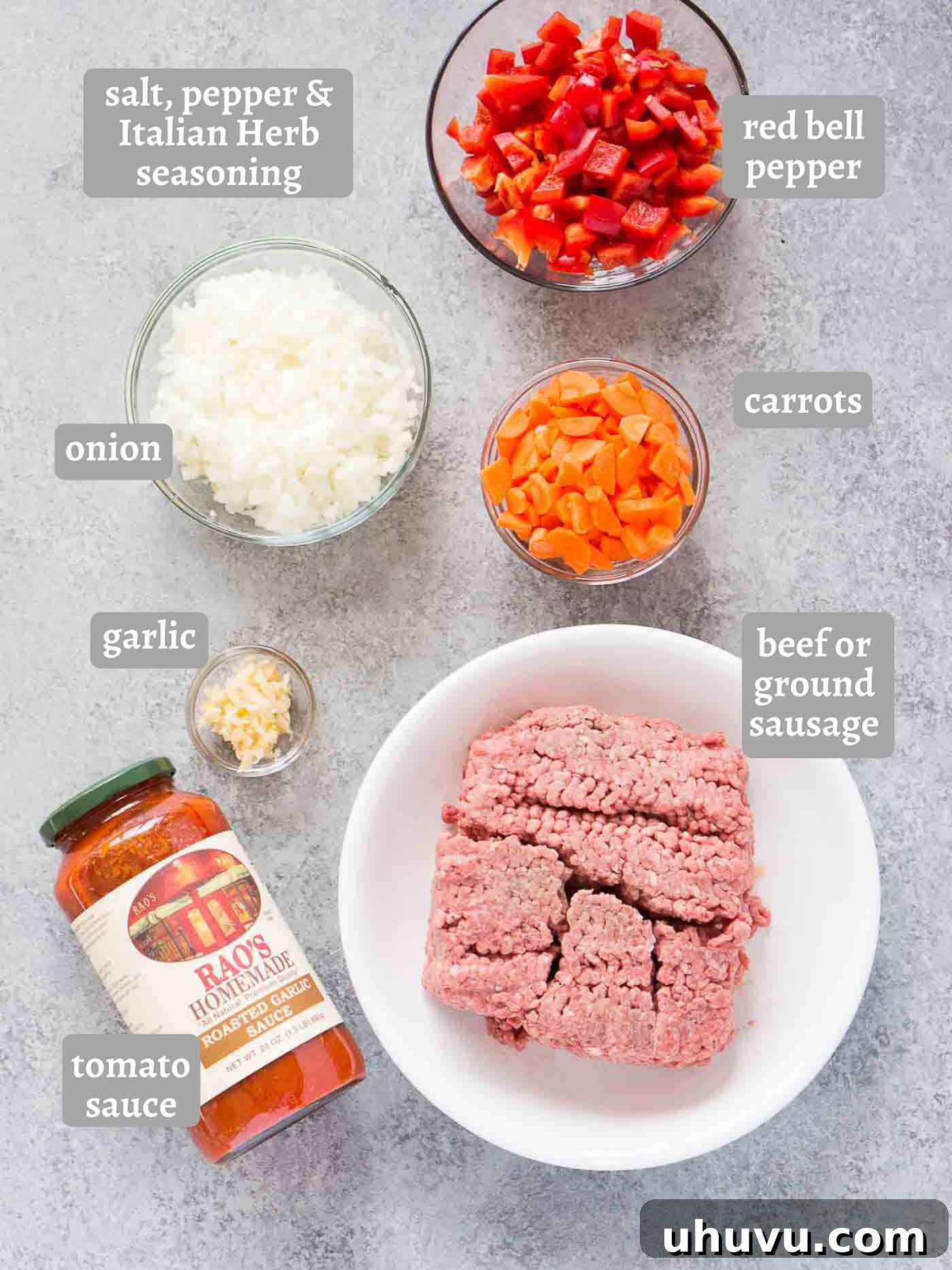 Ultimate Instant Pot Bolognese 4 A collection of fresh ingredients laid out, including ground beef, chopped red bell pepper, carrots, onion, garlic, and a can of tomato sauce, ready for making bolognese.