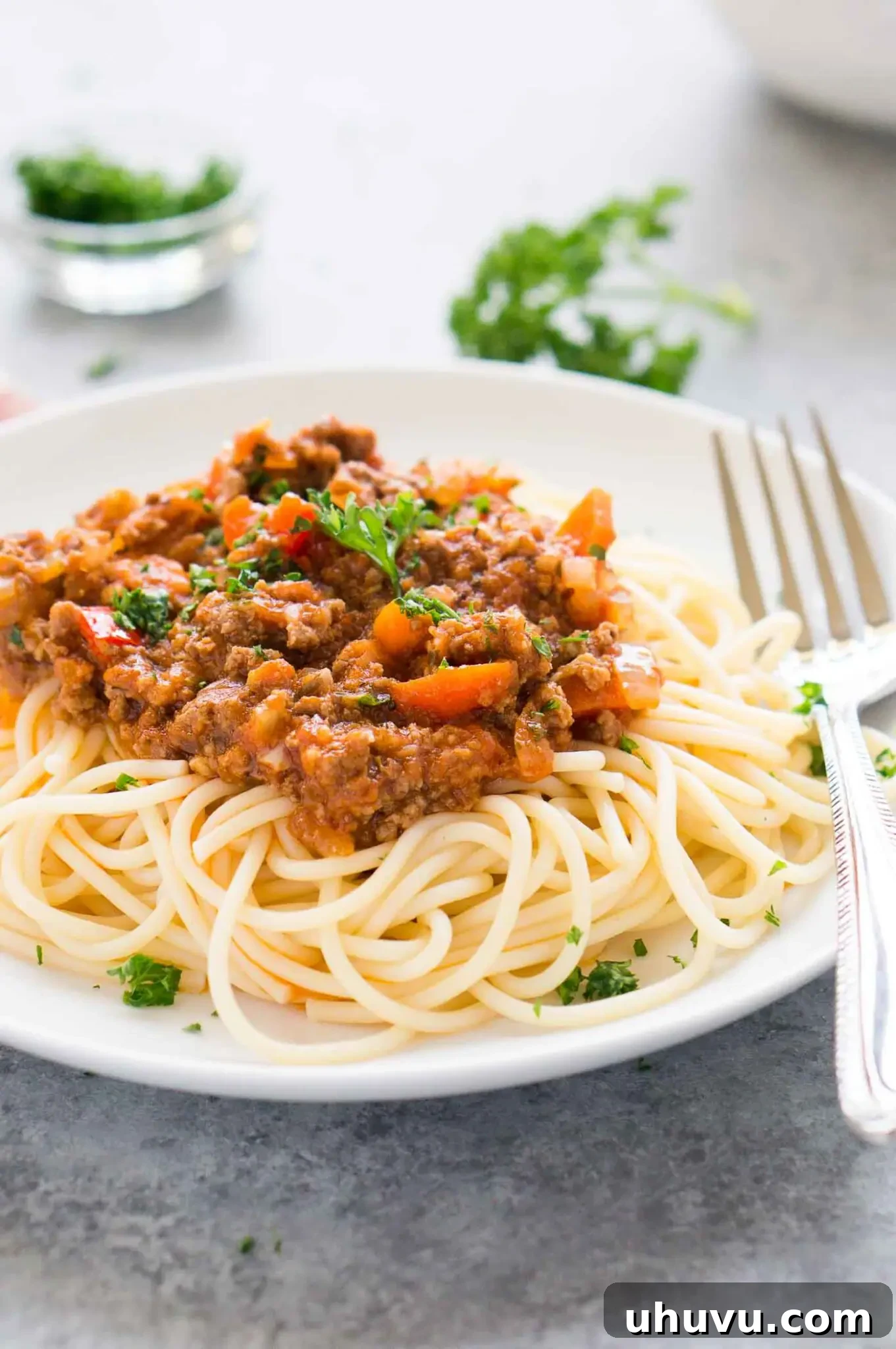 Ultimate Instant Pot Bolognese 6 A generous serving of Instant Pot Bolognese sauce over fresh pasta, glistening and ready to be served, highlighting its rich texture.