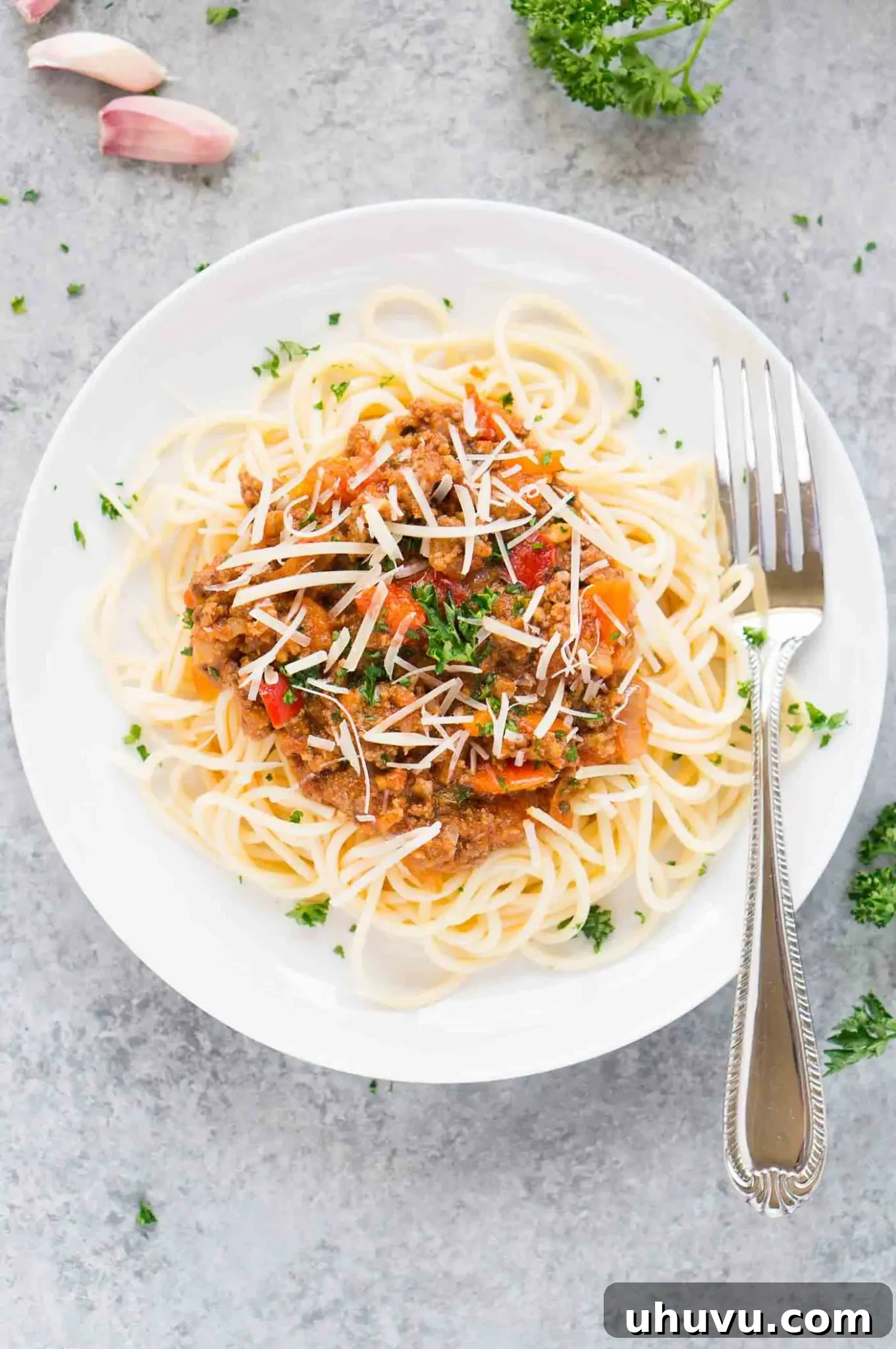 Ultimate Instant Pot Bolognese 7 A bowl of rich, homemade meat sauce, brimming with savory goodness, served over a bed of pasta, highlighting its hearty texture.