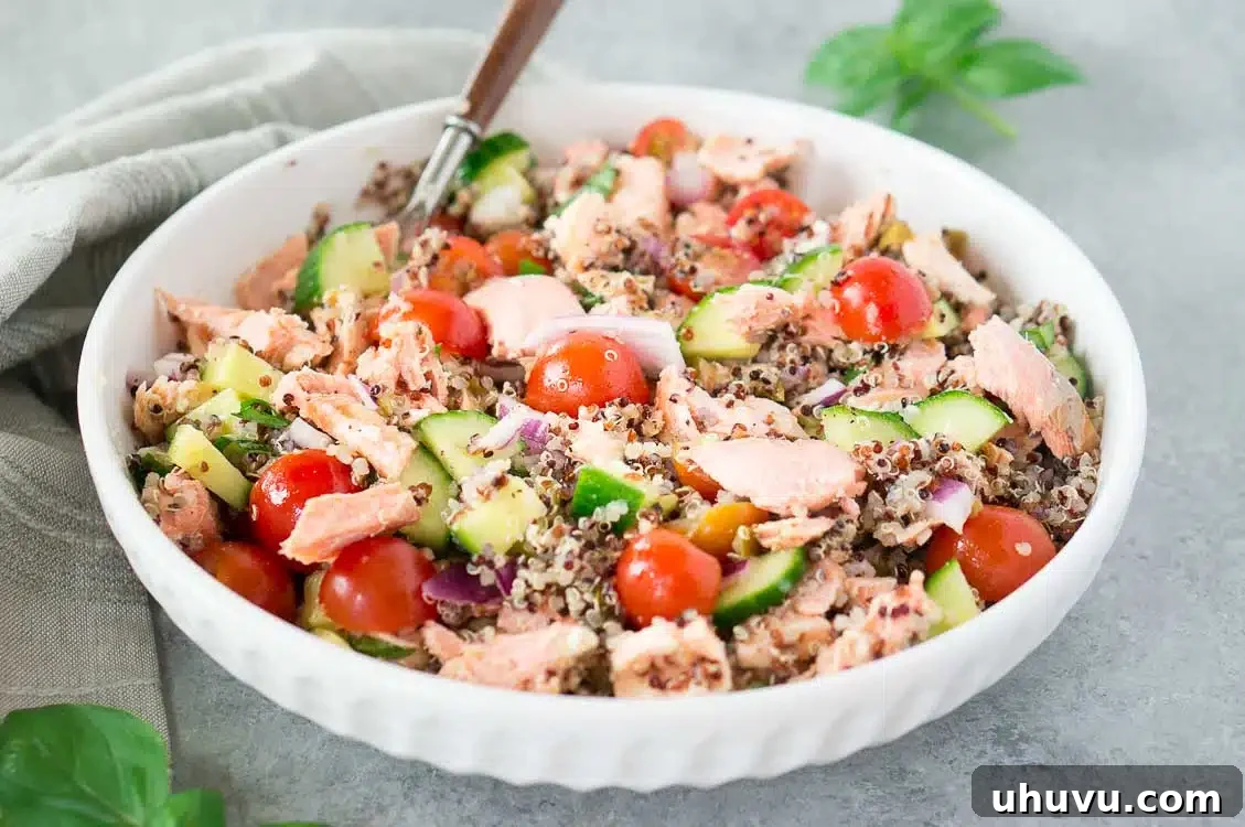 close-up of salmon salad with quinoa, highlighting fresh ingredients