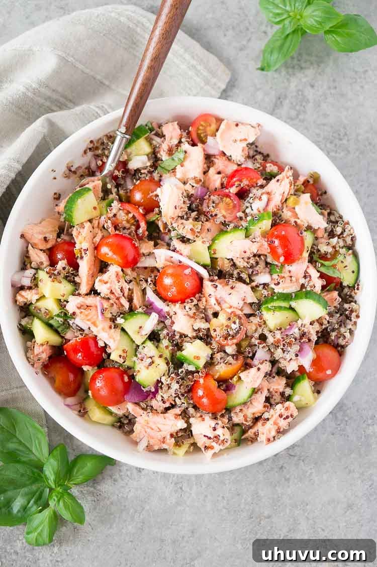 close-up of salmon and quinoa salad in a bowl with basil